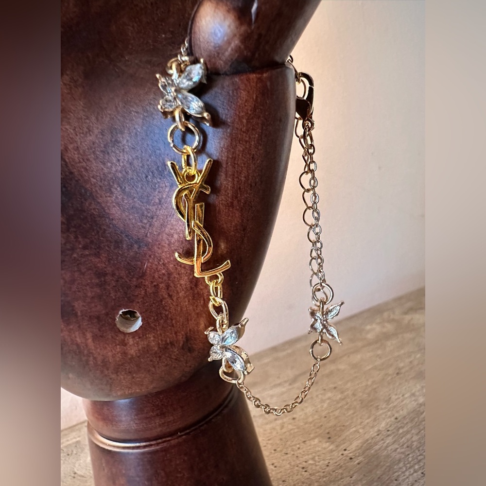 Gold tone bracelet with Butterflies and YSL charm logo